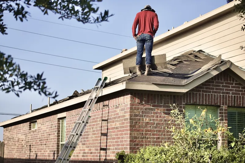 Professional roofer working on a residential roof in Clara Barton